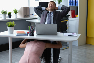 Satisfied male boss at desktop and woman molest under table - obrazy, fototapety, plakaty