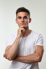 Portrait of young handsome athletic man in white t-shirt