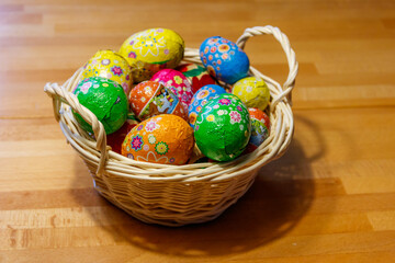 Basket with Easter eggs on wooden table