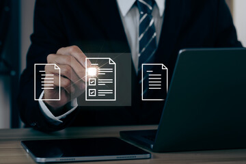 A businessman signs an electronic document on a digital document on a virtual notebook screen using a stylus pen. Paperless workplace idea, e-signing, electronic signature, document management.