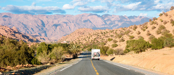 travel destination in Morocco- Motor home on the asphalt road in africa