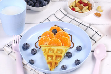 Ice cream. Waffles with fruits for children's breakfast. A creative idea for a fun kids dessert or breakfast