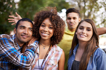 Good vibes with friends. Portrait of a group of young friends hanging out together outside.