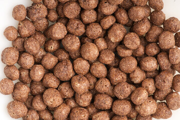 Chocolate breakfast in the form of balls in milk. Closeup