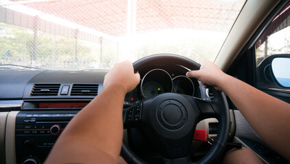 Man driving with both hands on steering wheel selective focus. safety driving car
