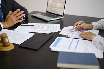 Legal counsel presents to the client a signed contract with gavel and legal law. justice and lawyer concept