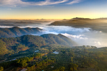 A group of young people watching the sunrise on top of a tea hill in Cau Dat, Da Lat town, Lam Dong province, Vietnam