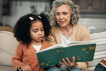 Adoption child, book and grandmother reading fantasy storybook, story or bonding on home living room sofa. Family love, grandma and senior woman with youth development for learning kindergarten girl