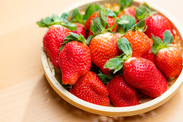 Ripe strawberries in a woven basket