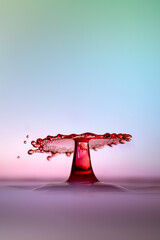 Moment of water drops colliding on pink background. Abstract natural background