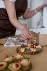 Diet menu, healthy food, ready snack delivery concept. Chef's hands in the frame packing takeaway food delivery