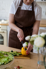 Cooking in the kitchen diet menu, healthy food, ready snacks delivery concept. Hands of the chef in the frame cutting vegetables