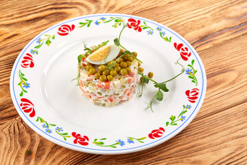 russian salad on the wooden background