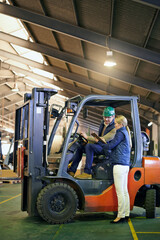 Lets get things moving around here. driver in a forklift and a manager on the factory floor.
