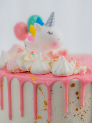 pink frosted dripping icing white birthday cake cake with unicorn , meringue and sprinkles toppers,...