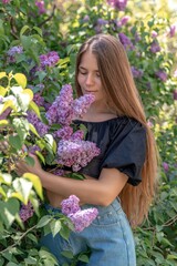 portrait of young woman with long hair outdoors in blooming lilac garden