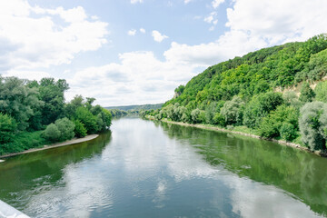 Fototapeta na wymiar Breiter Fluss mit viel Bäumen umrahmt schönes Wetter 
