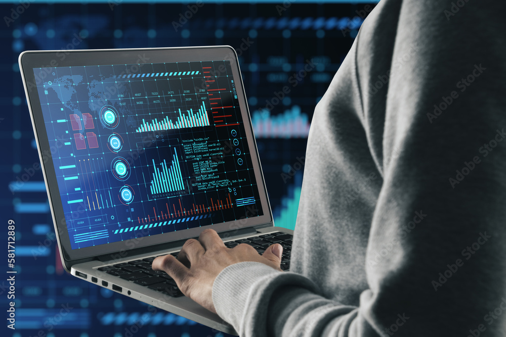 Poster Close up of hacker hand using laptop with glowing digital interface with business charts and coding on dark background. Future and cyberspace concept.