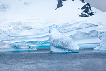 Stark, stunning and each unique, huge icebergs are sculpted by nature and weathered by changing climate as they float slowly through the antarctic oceans.