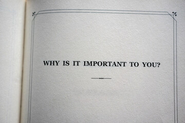 A wisdom ' why is it important to you? ' written in capital letters on a blank white book page. A...
