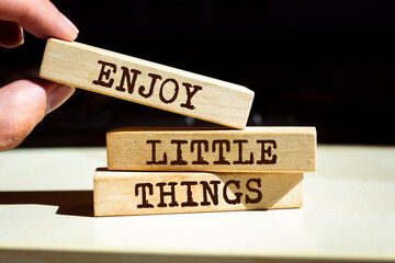 Wooden blocks with words 'Enjoy Little Things'.