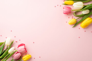 Spring holidays concept. Top view photo of yellow white pink tulips and sprinkles on isolated light pink background with copyspace - obrazy, fototapety, plakaty