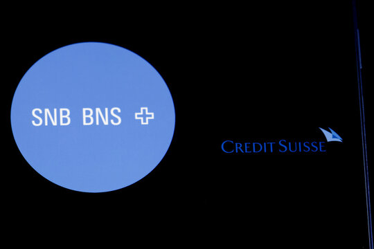 Smartphone with Credit Suisse black logo on background of SNB BNS (Swiss National Bank) description on computer screen, Switzerland, March 16, 2023 
