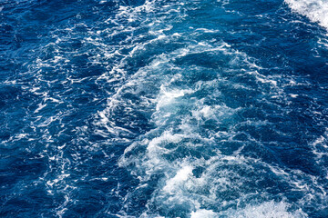 Very nice sea water background or backdrop with selective focus. Small waves of natural water surface texture.