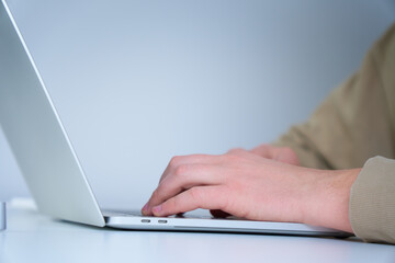 IT specialist typing on laptop keyboard. Close up view of hands. CEO manager working at his own workplace from home. Confident manager.