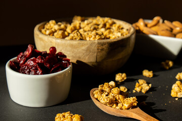 Homemade granola with nuts and seeds. Healthy snack on breakfast. Granola, homemade muesli from oatmeal, raisins, honey, cranberry, flax, almond, macadamia, cashew, freshly baked 