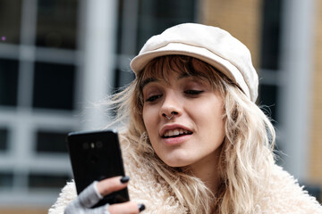 Beautiful young woman looking at her phone.