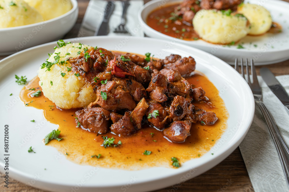 Sticker Meat dish with potato dumplings on a plate