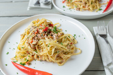 Pasta aglio e olio with tuna. Tagliatelle with olive oil, garlic, parsley and chili. Italian cuisine