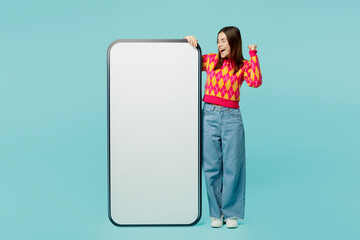 Full body young woman wears bright casual clothes big huge blank screen mobile cell phone...