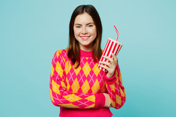 Young smiling cheerful fun woman wearing bright casual clothes hold cup of soda pop cola fizzy...