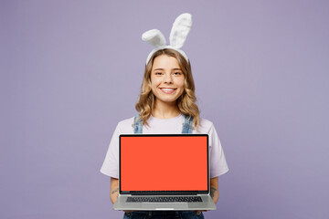 Young IT woman wearing casual clothes bunny rabbit ears hold use working on blank screen area...