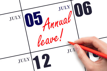 Hand writing the text ANNUAL LEAVE and drawing the sun on the calendar date July 5