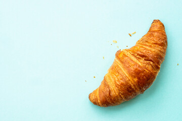 Croissant at blue background. French bakery. Flat lay.