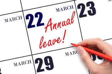 Hand writing the text ANNUAL LEAVE and drawing the sun on the calendar date March 22