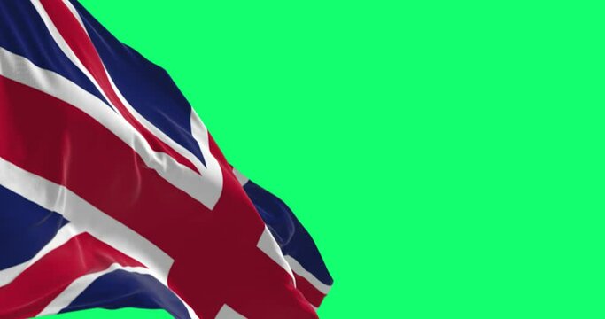 Seamless loop in slow motion of the United Kingdom flag waving isolated on a green background