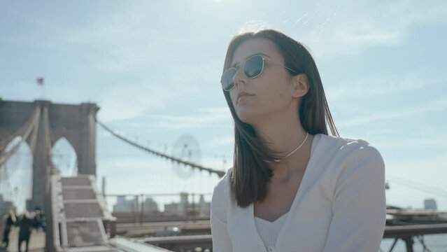 Cute girl looking around on a Brooklyn bridge, New York
