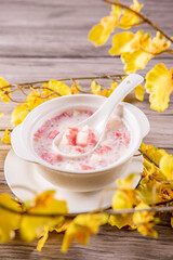 traditional ice cold chilled colourful fruit peach gum bo bo cha cha sweet soya bean coconut milk soup in white bowl on wood background sweet dessert halal menu