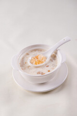 traditional ice cold chilled colourful fruit peach gum bo bo cha cha sweet soya bean coconut milk soup in white bowl on wood background sweet dessert halal menu