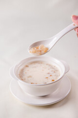 traditional ice cold chilled colourful fruit peach gum bo bo cha cha sweet soya bean coconut milk soup in white bowl on wood background sweet dessert halal menu
