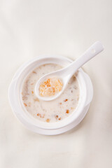 traditional ice cold chilled colourful fruit peach gum bo bo cha cha sweet soya bean coconut milk soup in white bowl on wood background sweet dessert halal menu