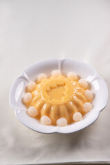 ice cold cute yellow mango fruit pudding big xmas tree mould jelly in plate with longan fruit decor on wood table asian cafe sweet kids dessert halal food restaurant menu