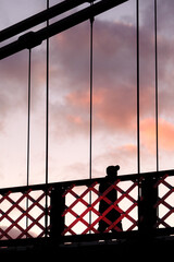 silhouette of a person crossing a bridge in Glasgow