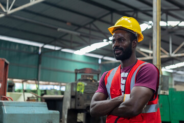 Portrait engineering male african american happy smiling workers wear yellow hard hat red uniform standing at factory industrial. Man technician machinery professional at workplace.