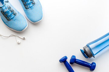 Sport fitness tools - sneakers and dumbbells, top view