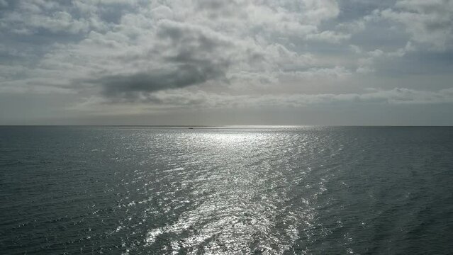 Aerial views over beaches with calm and relaxing waves along the shore.